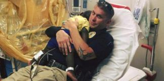 Picture captures a police officer comforting a scared toddler in the hospital